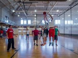 Group of students playing basketball in the gym