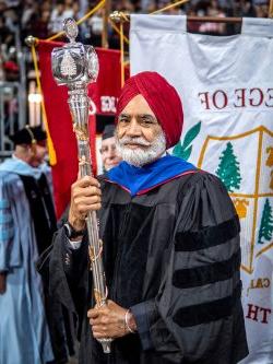 Harbans Singh holding the university mace and leading the commencement processional