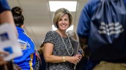 Photo of teacher in crowded high school hallway