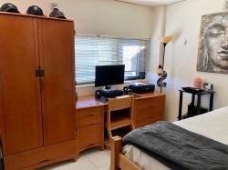 A desk and bed in a Single Room in Blanton Hall.
