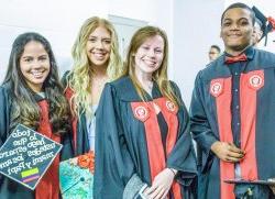 Image of students in cap and gown at a graduation ceremony.